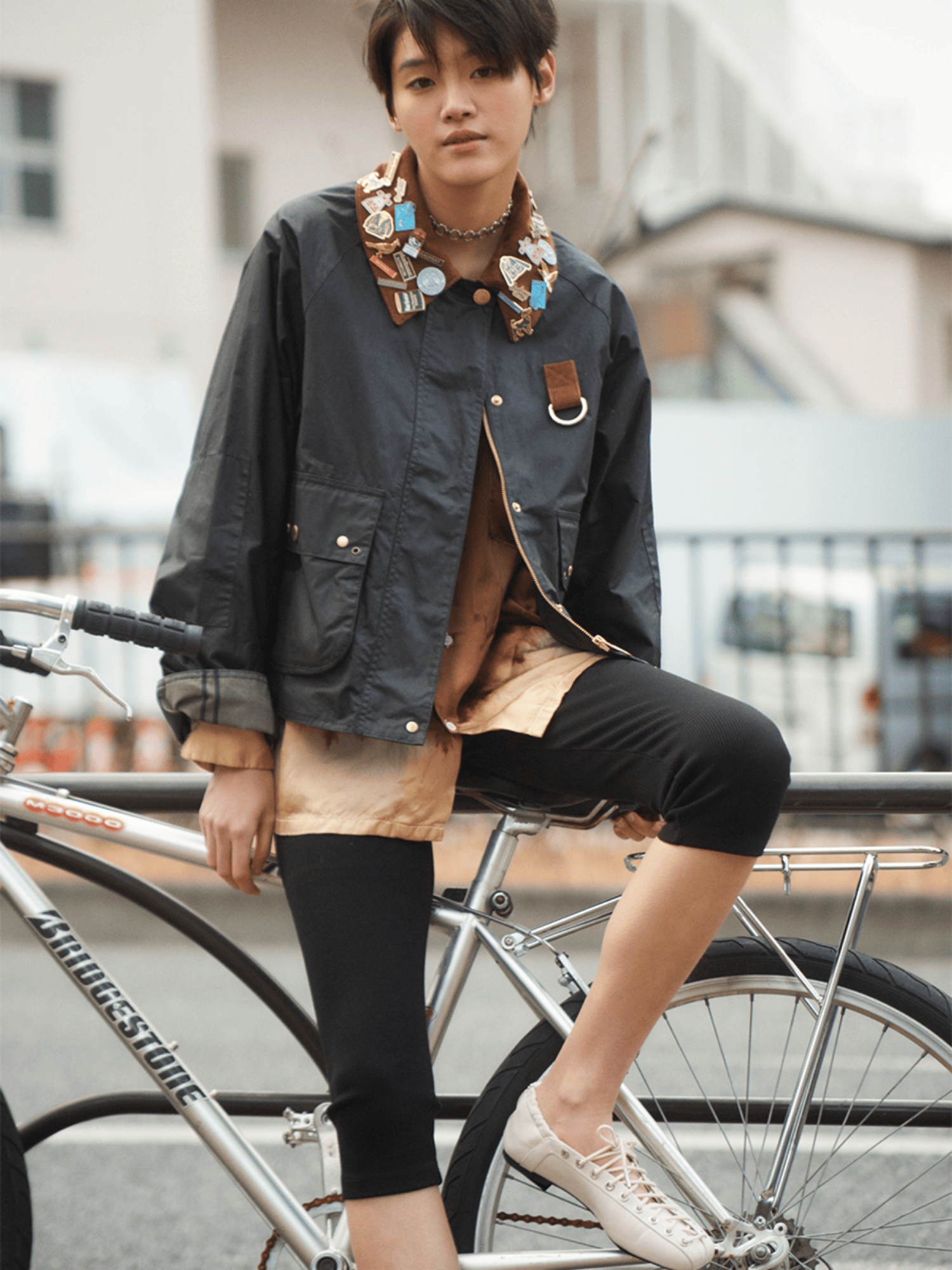 ジャケットを着用している女性が自転車にもたれかかっている女性画像